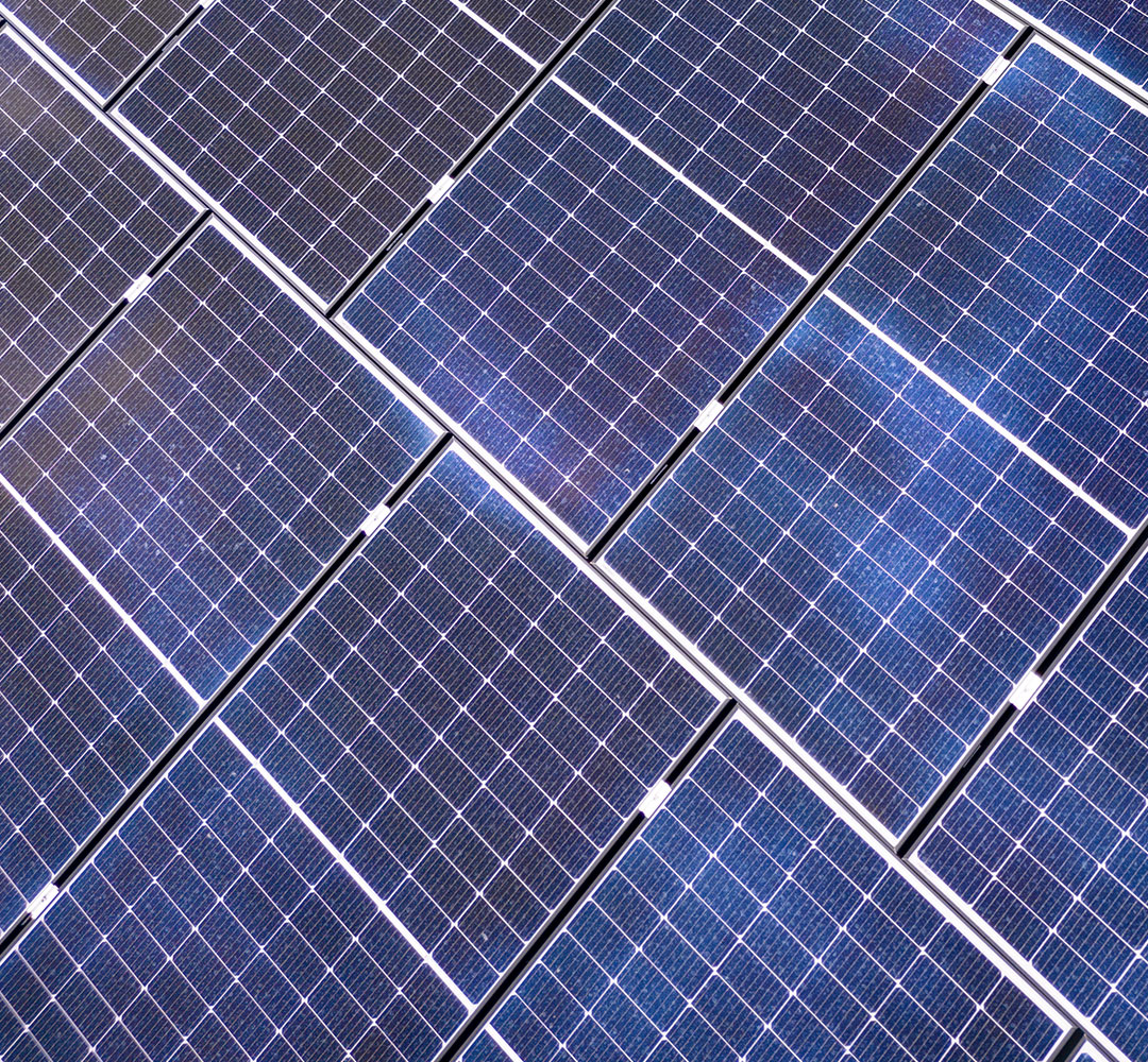 Detaillierte Nahaufnahme blauer Photovoltaik-Module, die effizient Sonnenenergie in Strom umwandeln.