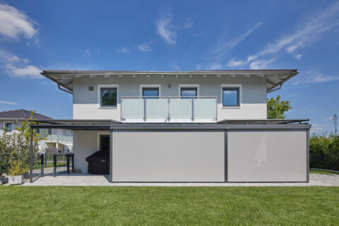 Modernes Einfamilienhaus mit Terrassenüberdachung, Aufdachmarkise und Seitenmarkisen für optimalen Sonnen- und Windschutz.