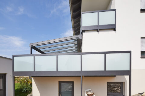 Moderne Terrassenüberdachung aus Aluminium und Glas, kombiniert mit Balkonbrüstungen aus Aluminium in Dorfen.