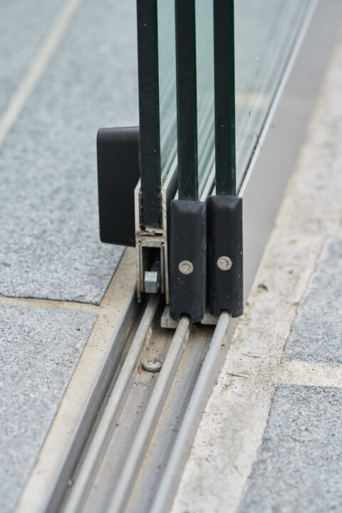 Detailansicht der versenkten Aluminium-Führungsschiene für Sunparadise Glasschiebeelemente in einem Kaltwintergarten.